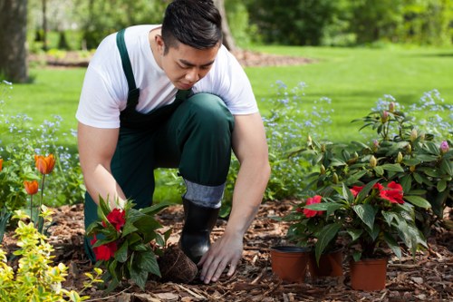 Operative performing a risk assessment on a garden site
